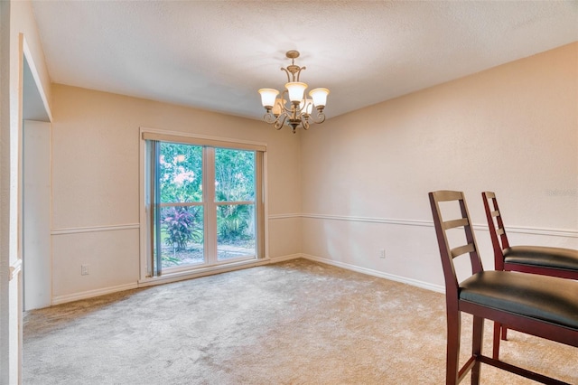 empty room featuring light carpet, a notable chandelier, and plenty of natural light