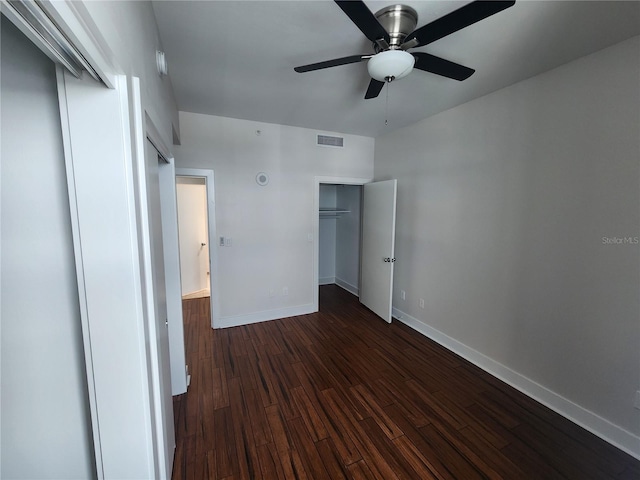 unfurnished bedroom featuring a closet, ceiling fan, and dark hardwood / wood-style flooring