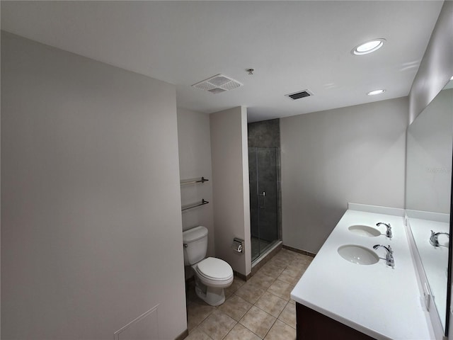 bathroom featuring tile patterned floors, vanity, toilet, and a shower with shower door