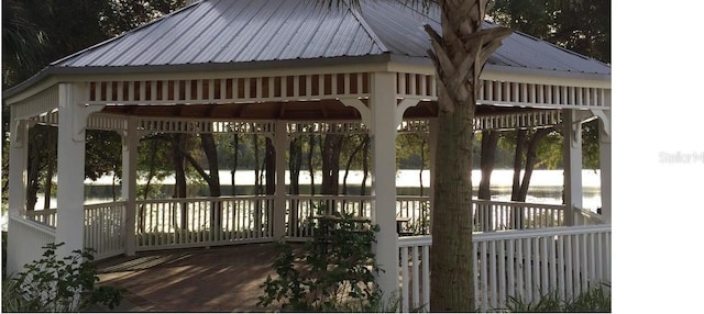 surrounding community featuring a gazebo and a water view