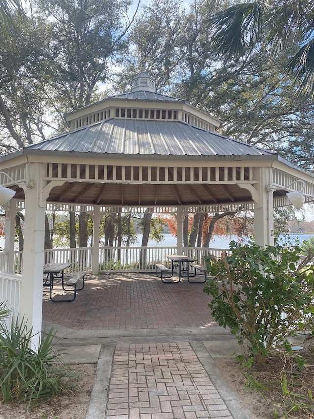 view of property's community with a gazebo and a water view