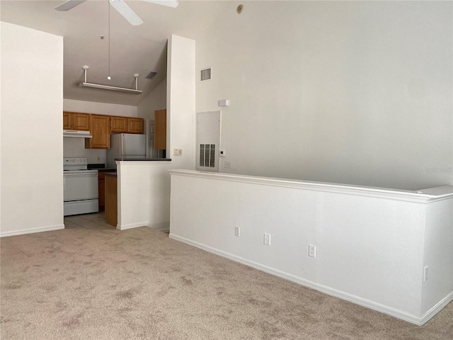 kitchen featuring high vaulted ceiling, electric range, stainless steel refrigerator, ceiling fan, and light colored carpet