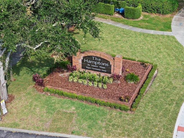 community sign featuring a lawn