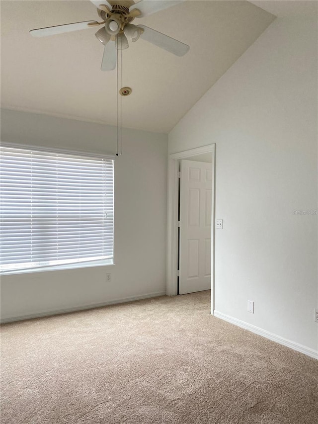 spare room with carpet floors, baseboards, lofted ceiling, and ceiling fan