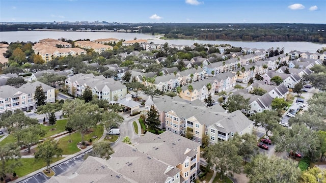 drone / aerial view featuring a water view and a residential view
