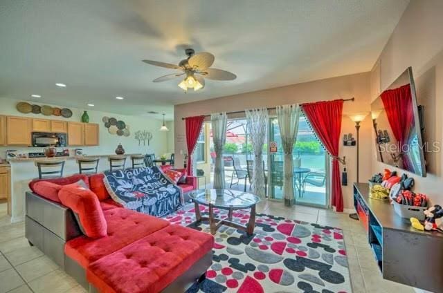 living room with ceiling fan and light tile patterned floors