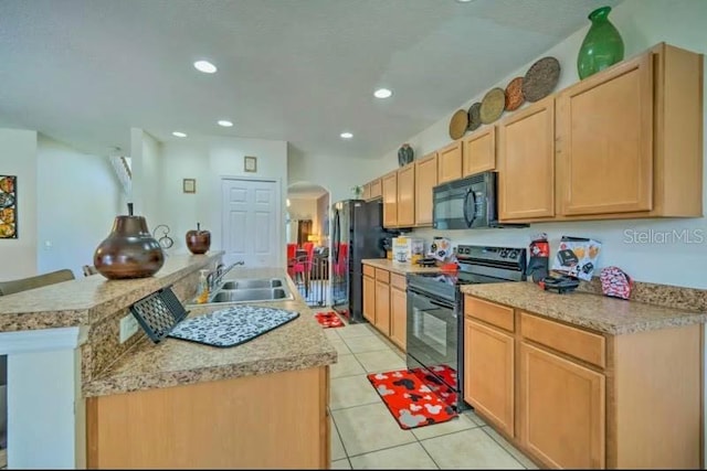 kitchen with black appliances, light tile patterned flooring, a center island, light brown cabinets, and sink