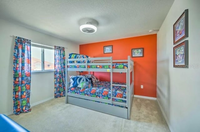 carpeted bedroom with a textured ceiling