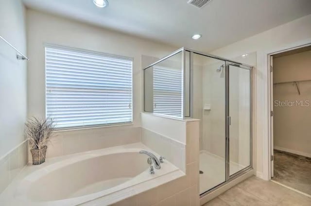 bathroom featuring plus walk in shower and tile patterned flooring