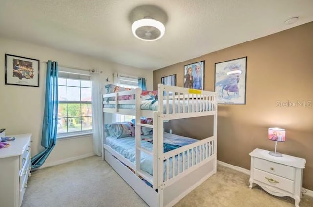 carpeted bedroom featuring a textured ceiling