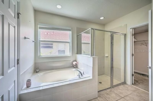 bathroom featuring tile patterned flooring and independent shower and bath