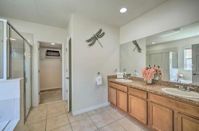 bathroom featuring tile patterned floors, vanity, and shower with separate bathtub