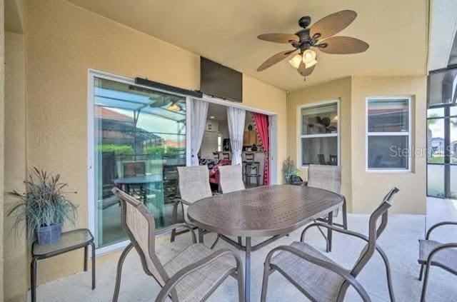 interior space with ceiling fan