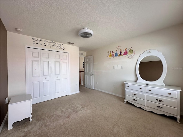 unfurnished bedroom with a textured ceiling, a closet, and carpet flooring