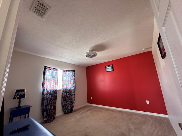 bedroom with carpet and a textured ceiling