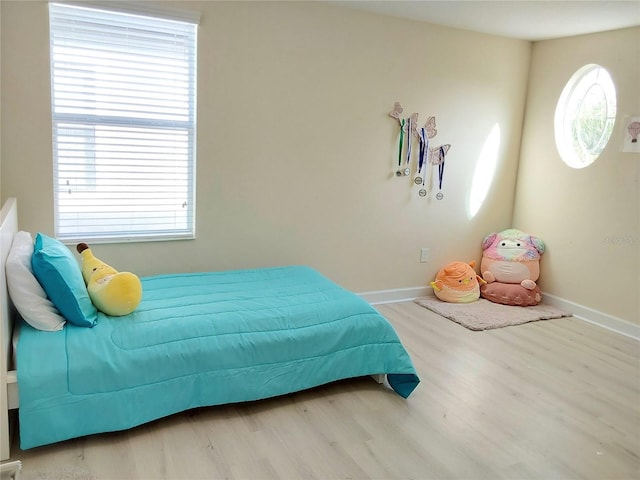 bedroom with hardwood / wood-style floors