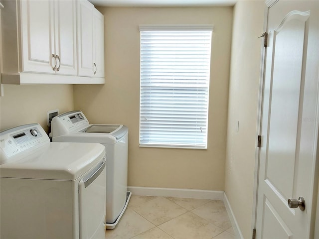 washroom featuring cabinets, separate washer and dryer, and light tile patterned floors