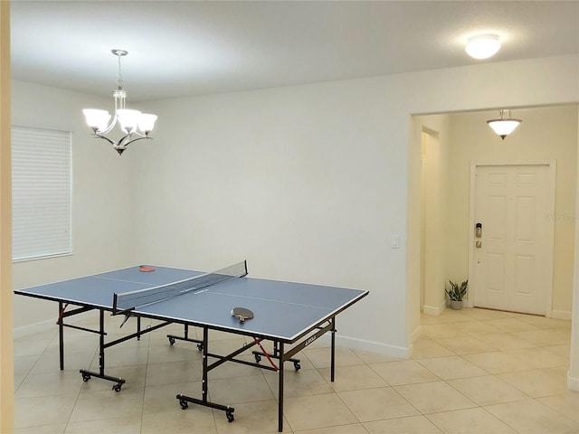 game room featuring light tile patterned floors and an inviting chandelier