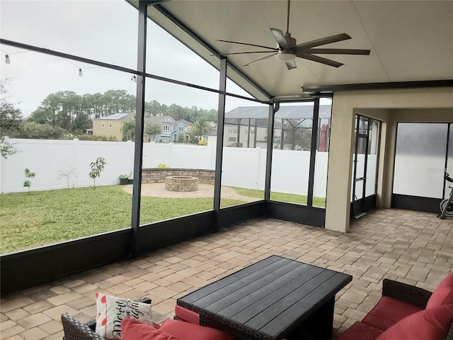 sunroom / solarium with ceiling fan and vaulted ceiling