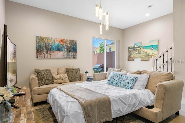 bedroom featuring a chandelier and dark hardwood / wood-style flooring