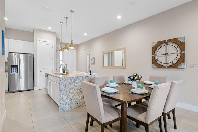 tiled dining space featuring sink