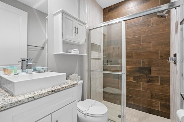 bathroom with vanity, walk in shower, and toilet