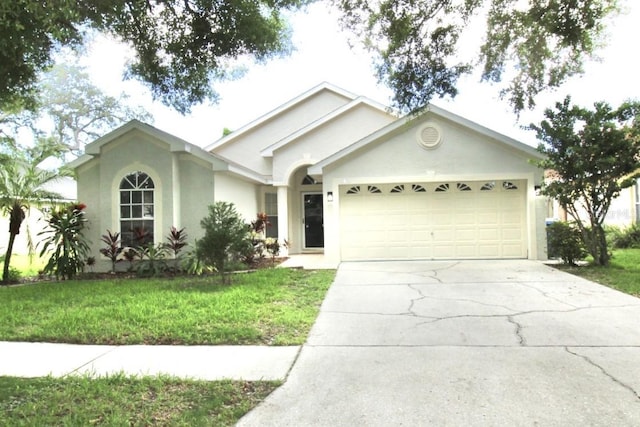 ranch-style home featuring a garage and a front yard