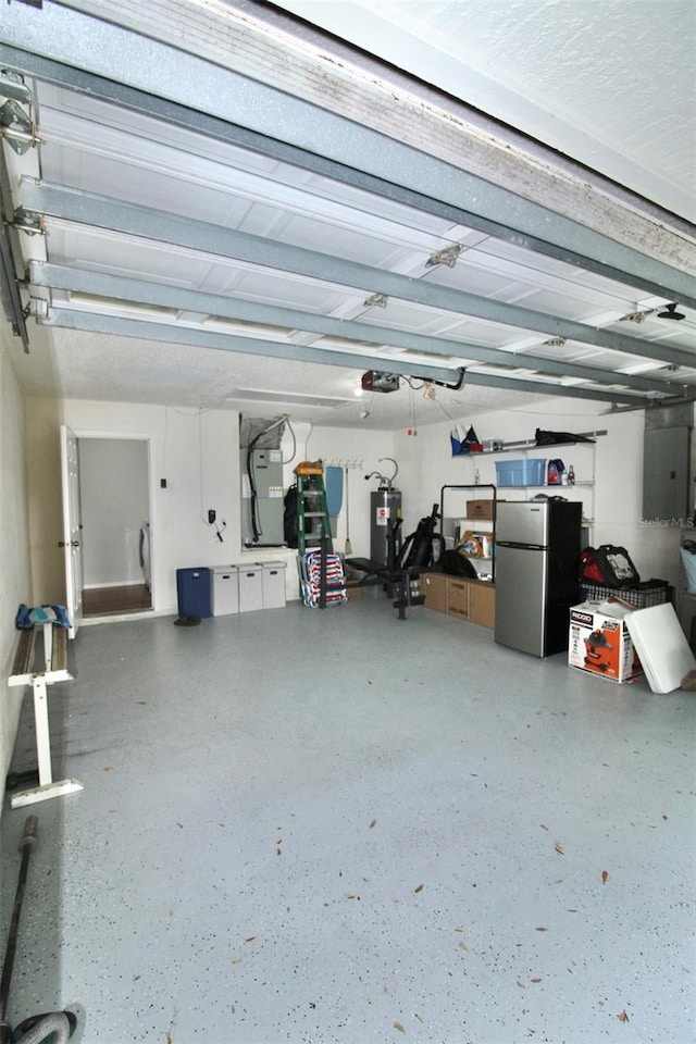 garage featuring stainless steel refrigerator and a garage door opener