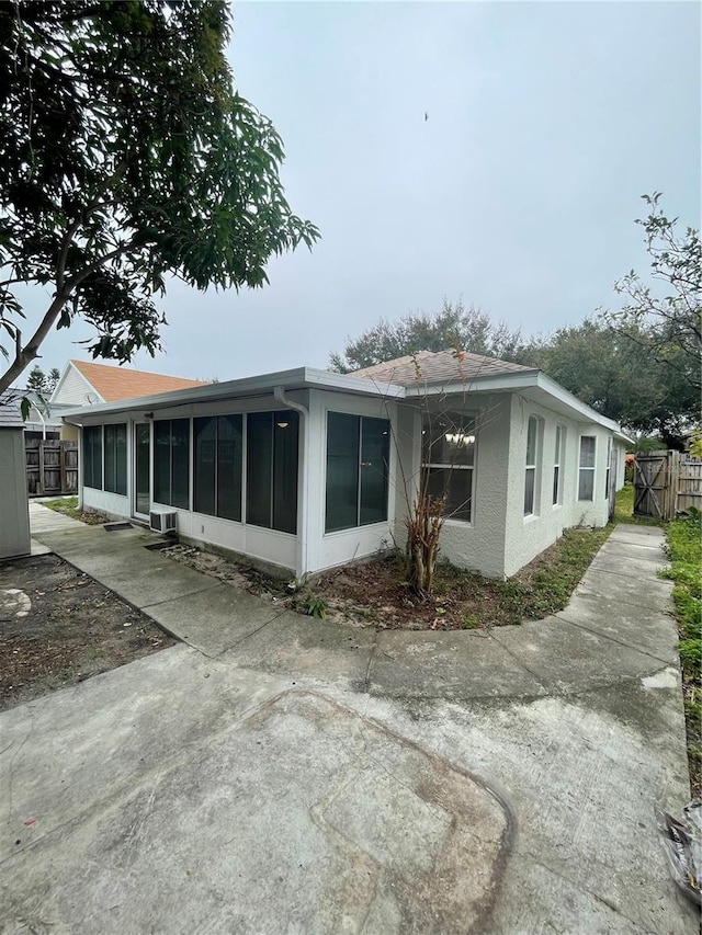 back of house featuring a sunroom