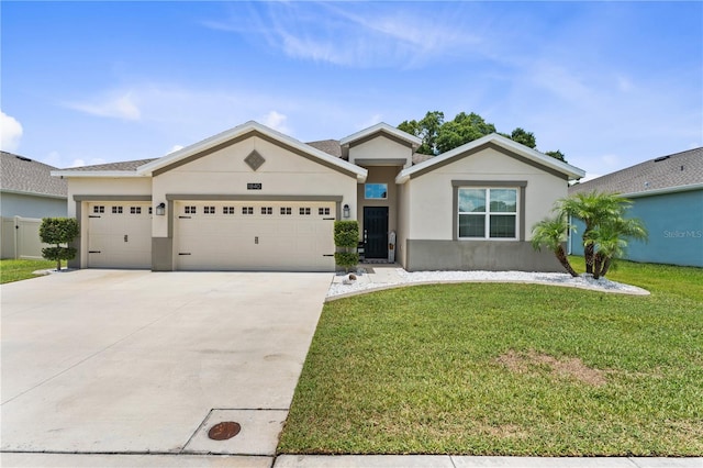 view of front of property with a garage and a front lawn