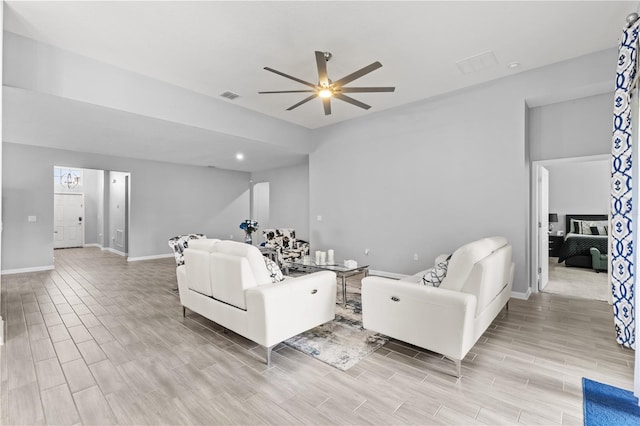 living room featuring light hardwood / wood-style flooring and ceiling fan