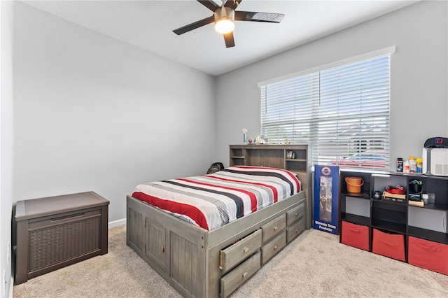 bedroom featuring light colored carpet and ceiling fan