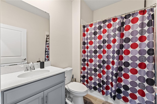 bathroom featuring tile patterned floors, vanity, and toilet