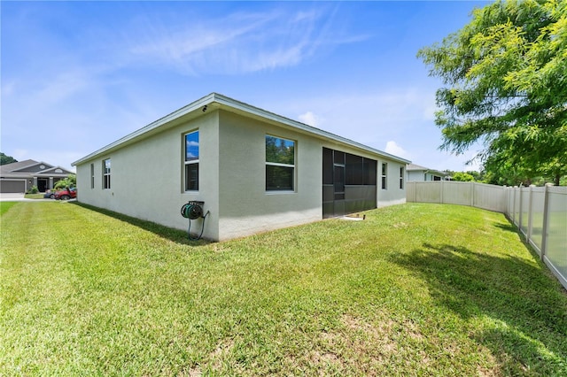 back of property featuring a lawn