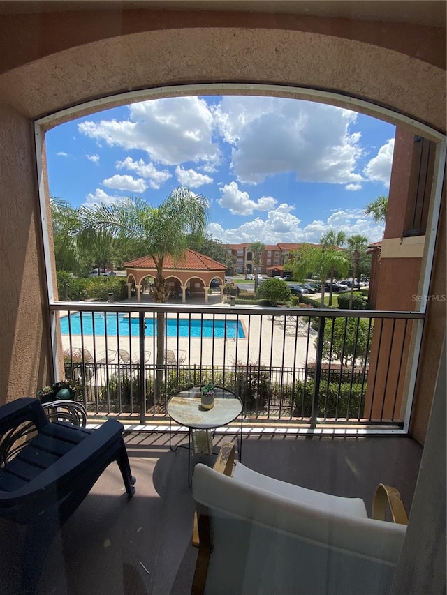 balcony with a fenced in pool