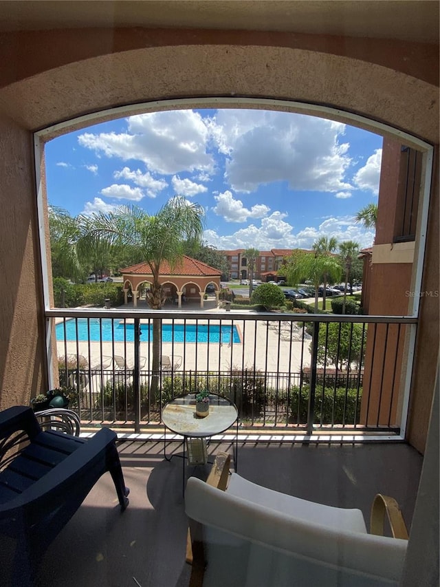 balcony featuring a fenced in pool