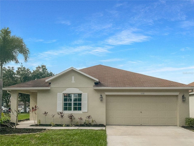 single story home with a front yard and a garage