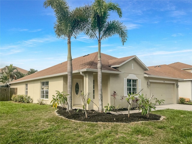 ranch-style house featuring a front yard and a garage