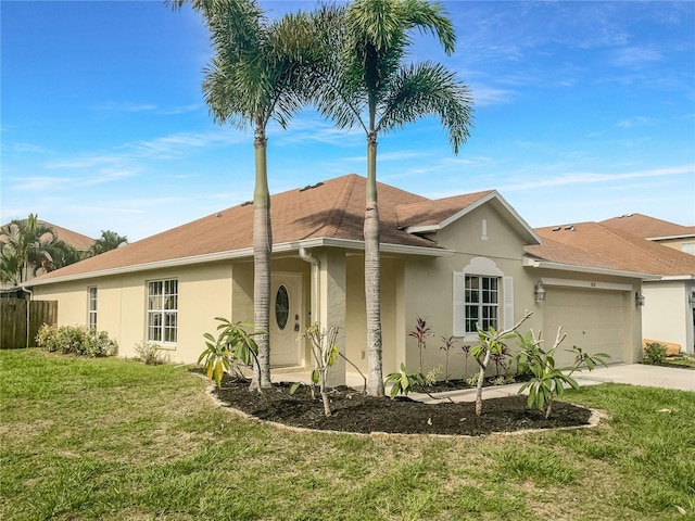 ranch-style home featuring a front yard and a garage