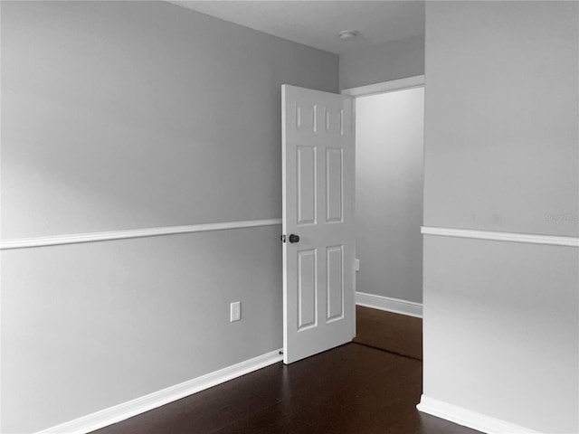 spare room with dark hardwood / wood-style flooring