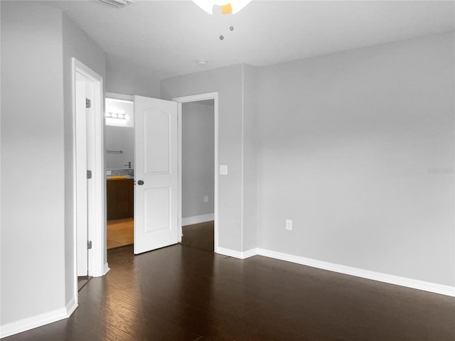 unfurnished bedroom featuring dark hardwood / wood-style flooring