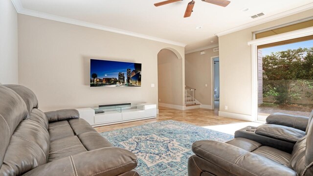 tiled living room featuring ceiling fan and ornamental molding