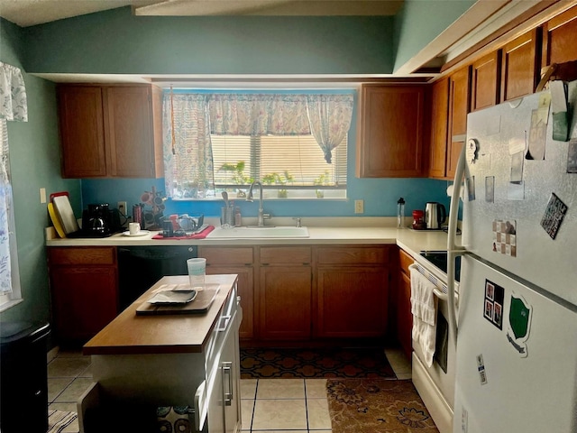 kitchen with sink, light tile patterned flooring, and white appliances