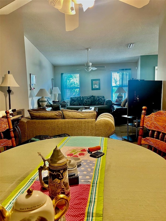 dining room featuring a textured ceiling and ceiling fan