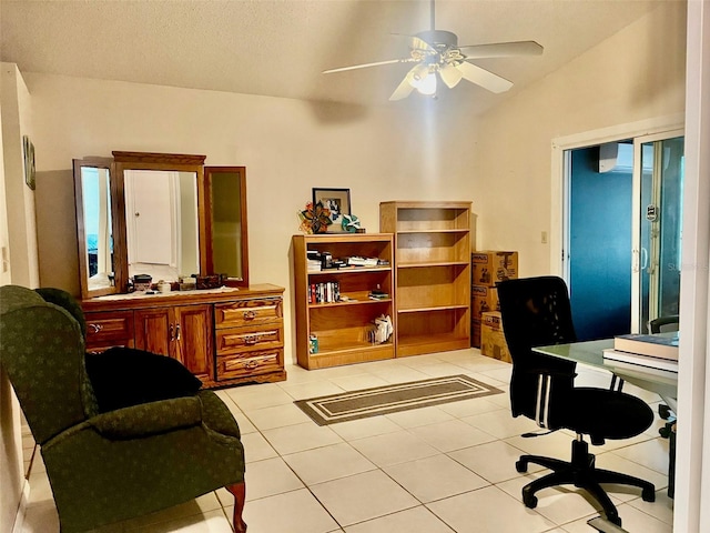 tiled home office featuring a textured ceiling, ceiling fan, and vaulted ceiling