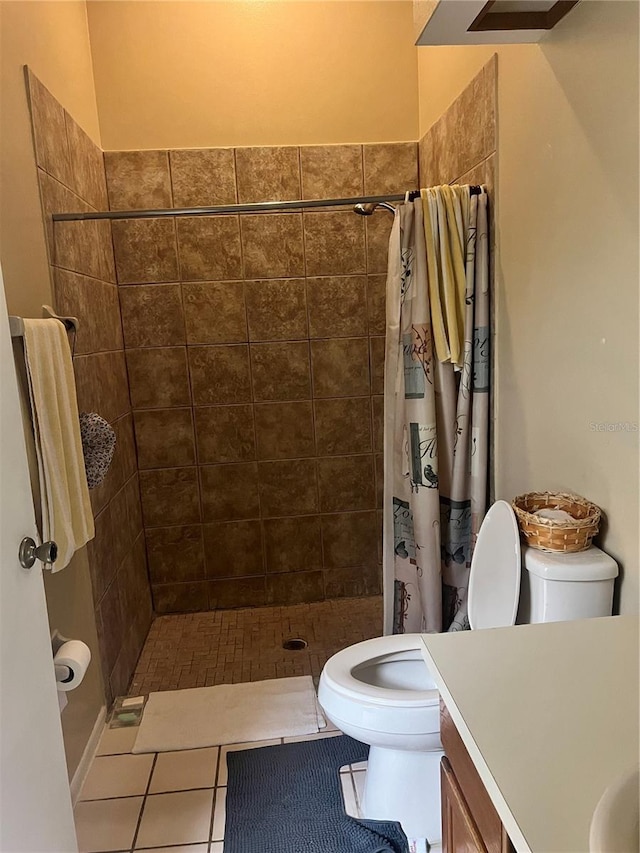 bathroom with vanity, toilet, tile patterned floors, and walk in shower