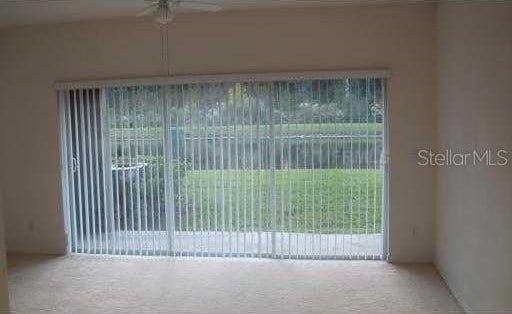 unfurnished room featuring carpet and ceiling fan