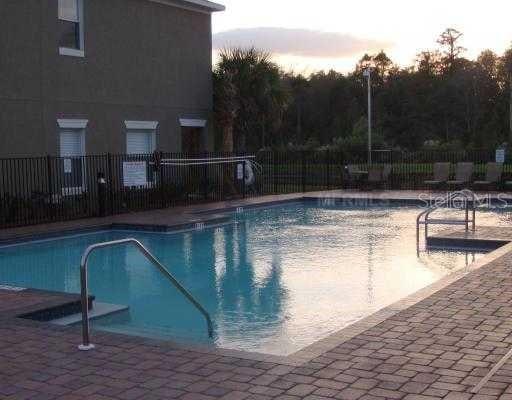 view of pool at dusk