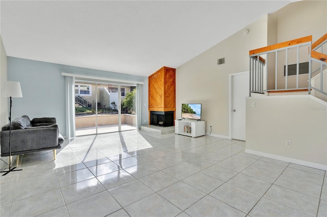 tiled living room featuring a multi sided fireplace and lofted ceiling