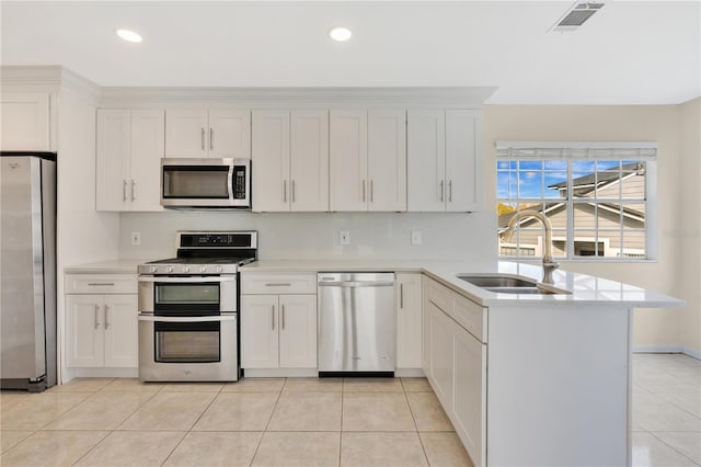 kitchen featuring white cabinets, sink, light tile patterned floors, and stainless steel appliances